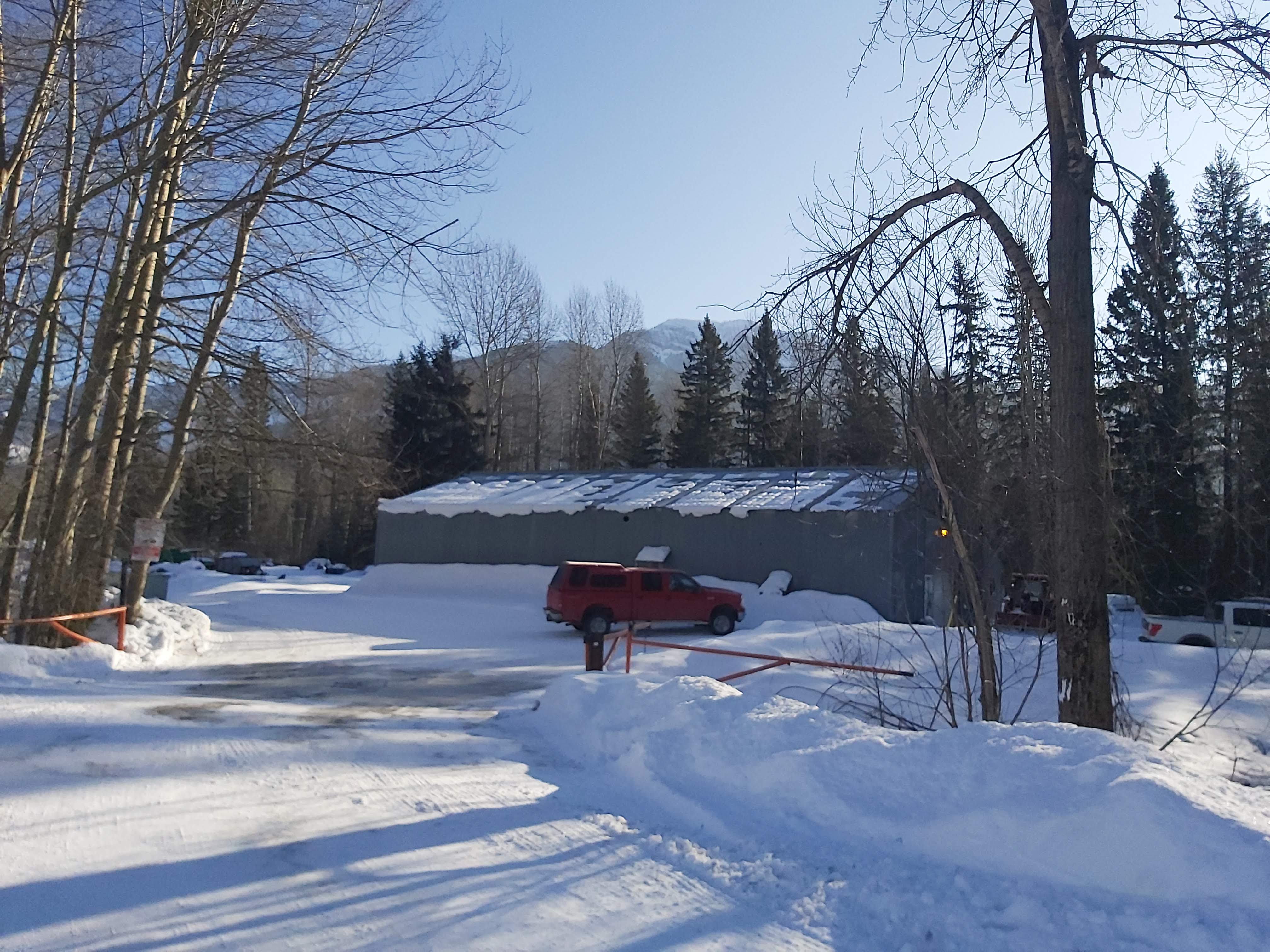 Red truck seen at the end of a road